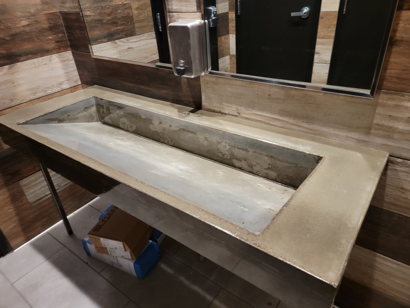 Custom concrete trough sink in restroom